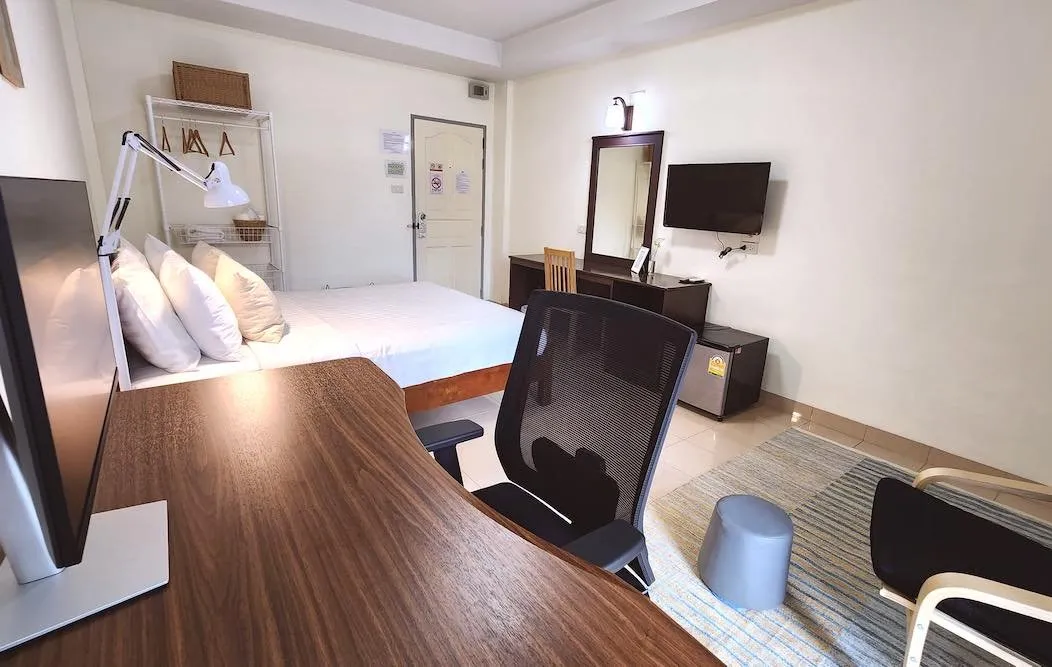 The Digital Nomad room bed and workspace